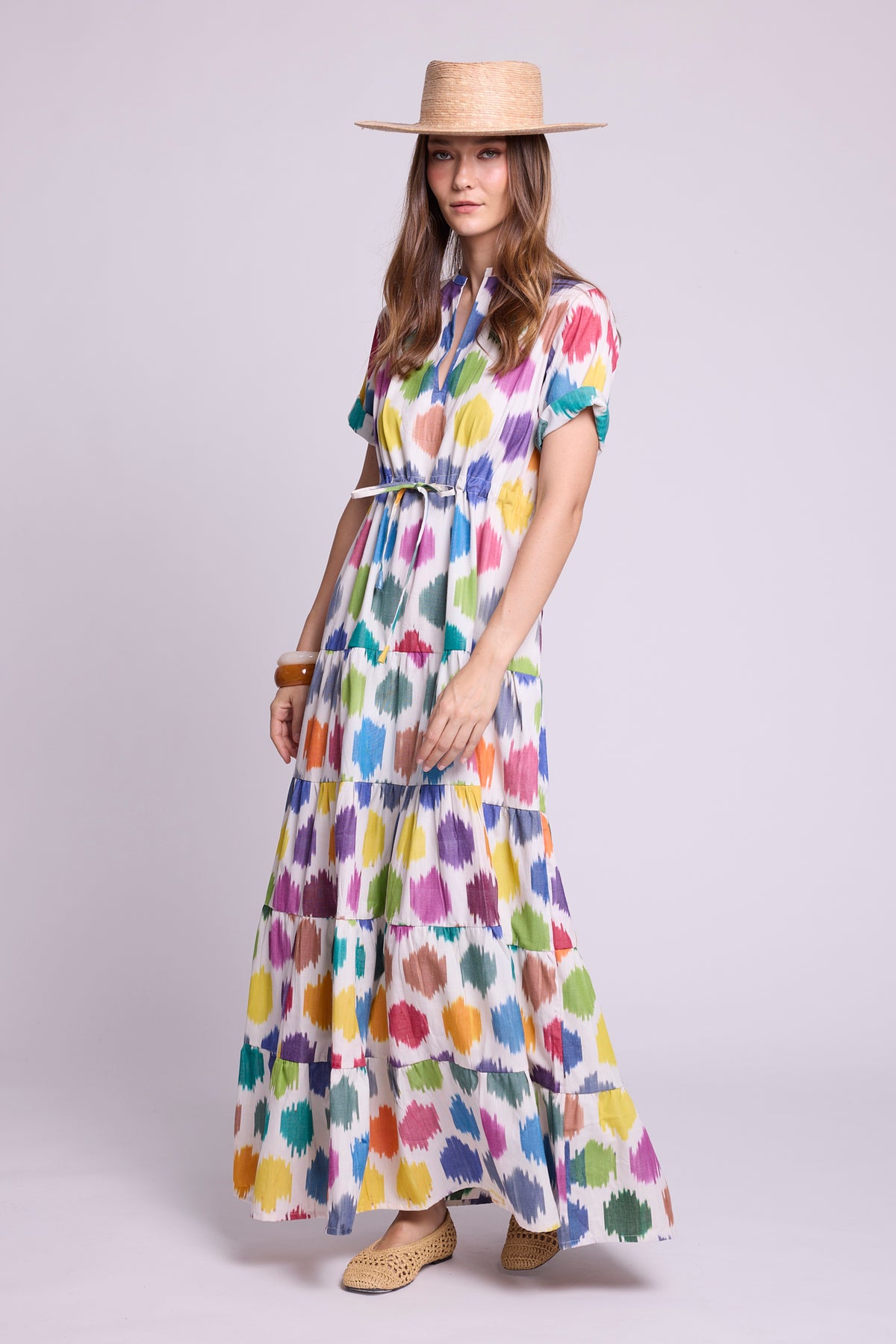 lookbook photo of model wearing kleed ikat cotton maxi dress with geometric motifs and a straw hat