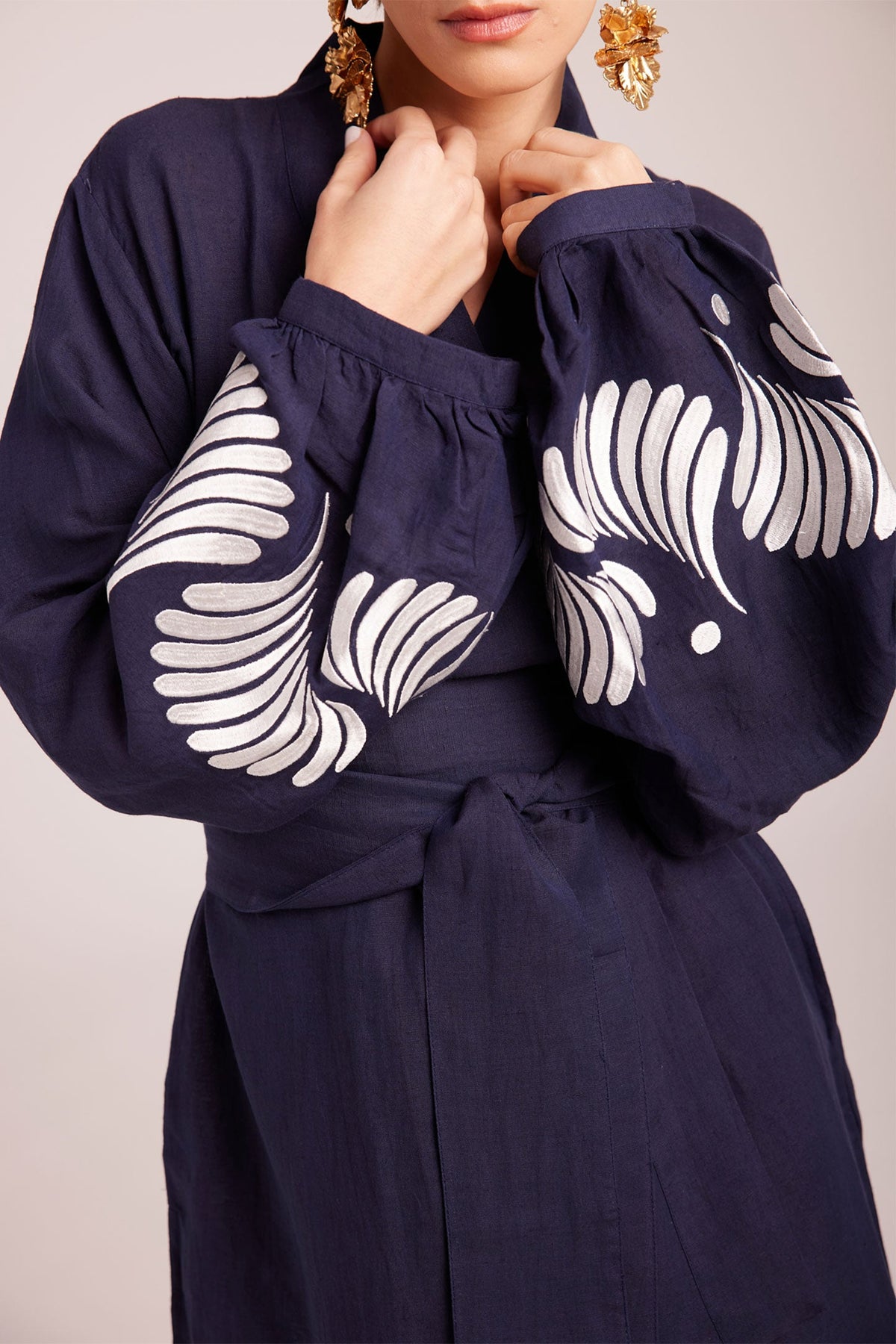 Close up of white floral hand embroidery on balloon sleeve cuffs of Kleed Blue Kandy Kimono in 100% cotton dark navy