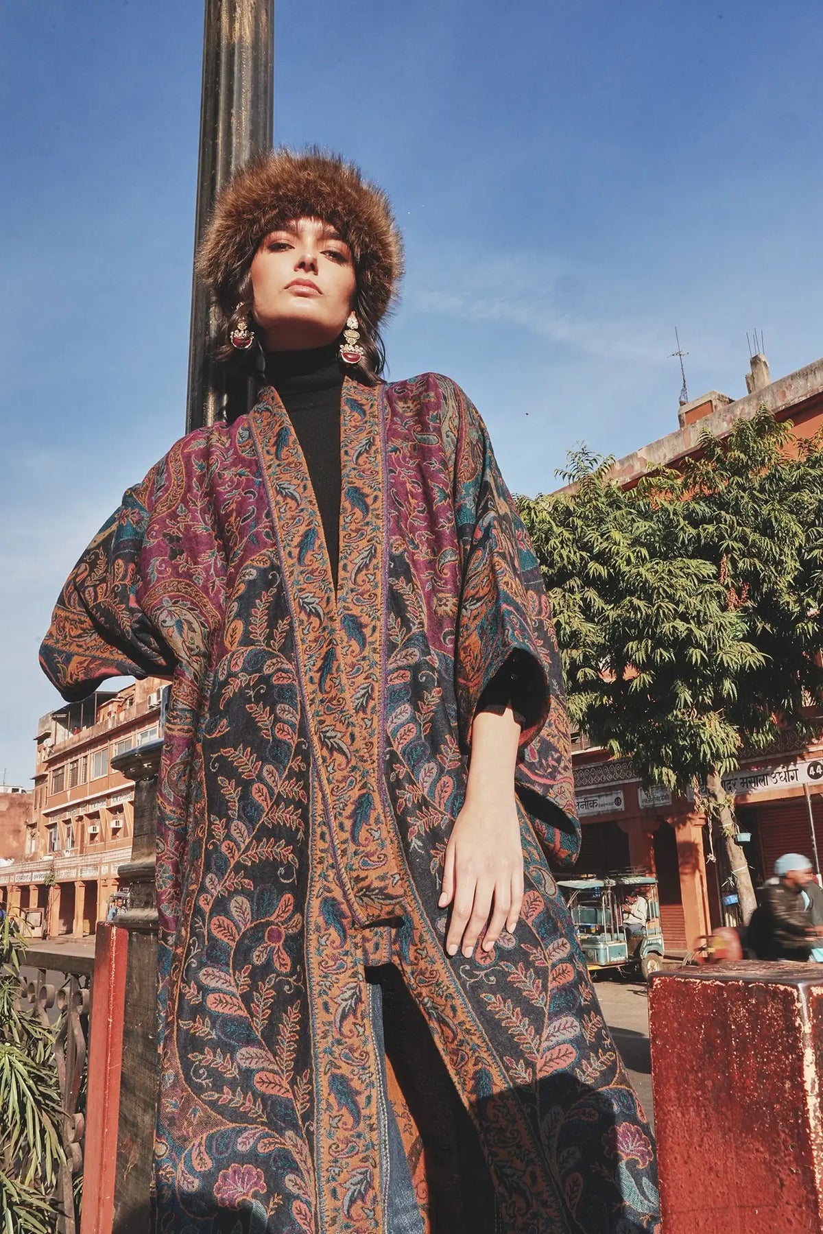 Kleed Fuchsia Paisley Kimono Coat in wool, urban editorial shot showing paisley print and long fluid silhouette.