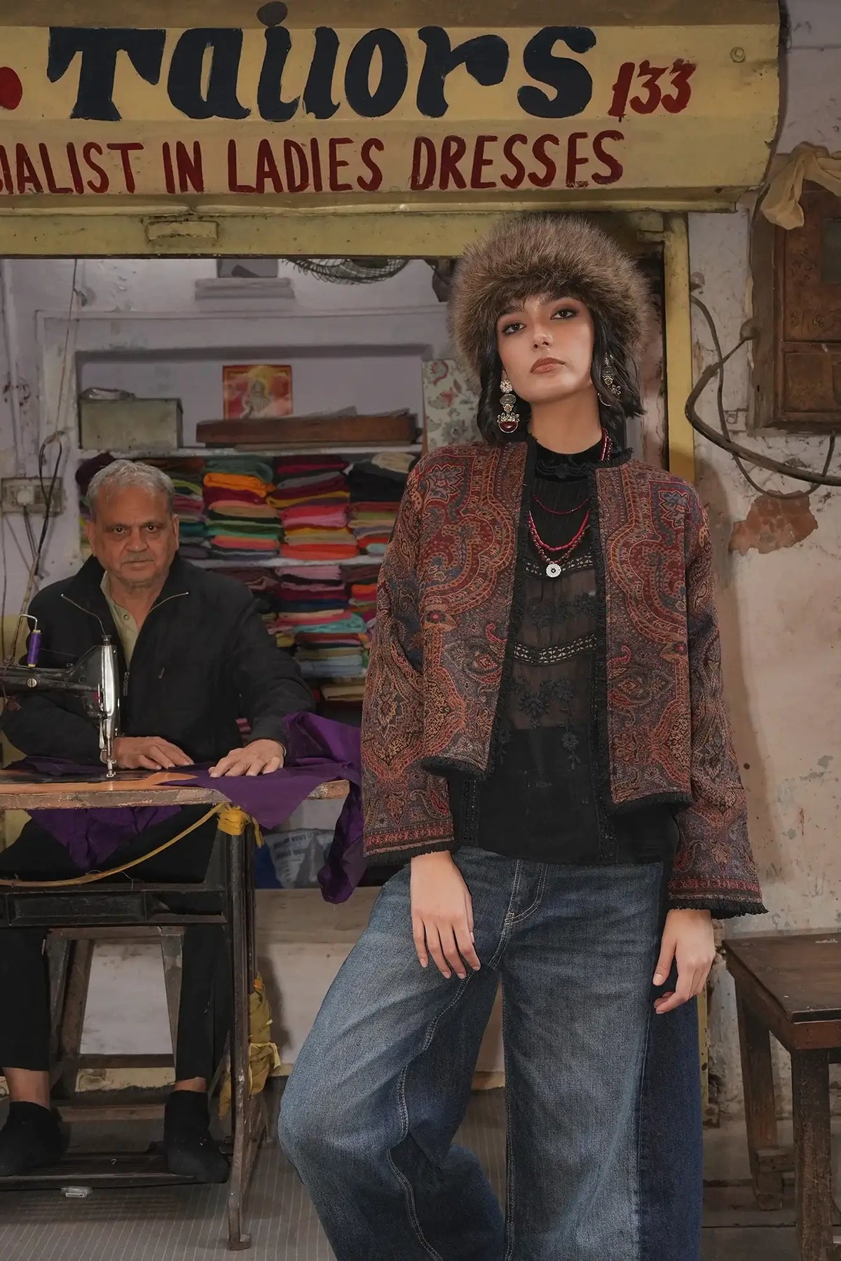 Kleed Blue Oak Jacket in wool with paisley print, editorial shot in a traditional tailor shop, styled with jeans.