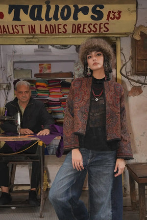 Kleed Blue Oak Jacket in wool with paisley print, editorial shot in a traditional tailor shop, styled with jeans.