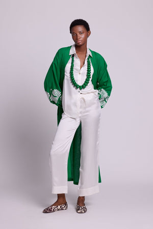 Full length front view of a woman wearing the Kleed Green Kandy Kimono in 100% cotton with white floral hand embroidered sleeves, styled with white silk pyama