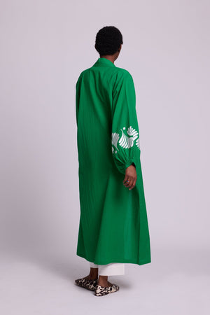 Back side view of a woman wearing the Kleed Green Kandy Kimono in 100% cotton showing the full length silhouette and white floral embroidered sleeve detail