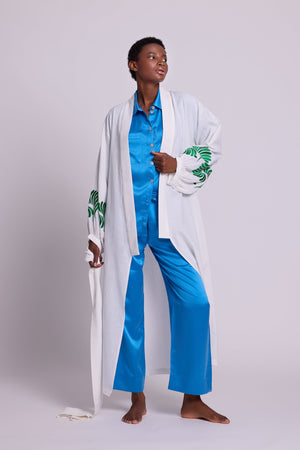 Full length view of Kleed Light Kandy Kimono in white cotton, styled over a sky blue silk pyjama set.
