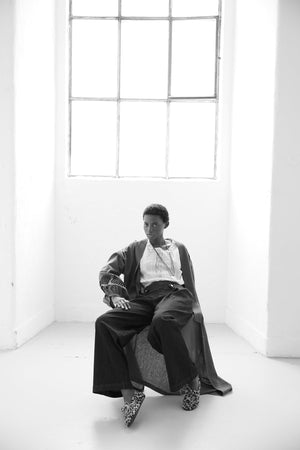 Editorial close-up of Kleed Olive Kandy Kimono in khaki cotton with black floral embroidered sleeves.