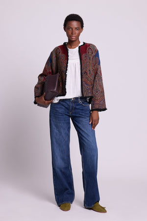 Full length view of Kleed Blue Oak Jacket in pure wool with indigo paisley print, styled with white top and wide-leg jeans.

