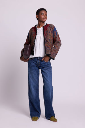 Front view of Kleed Blue Oak Jacket in wool with indigo paisley print, styled with white top and blue jeans.