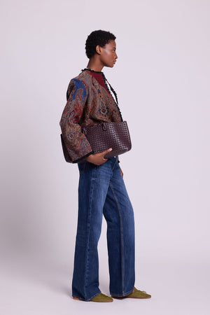 Side view of Kleed Blue Oak Jacket in pure wool with indigo and burgundy paisley print and raw-edged trim.