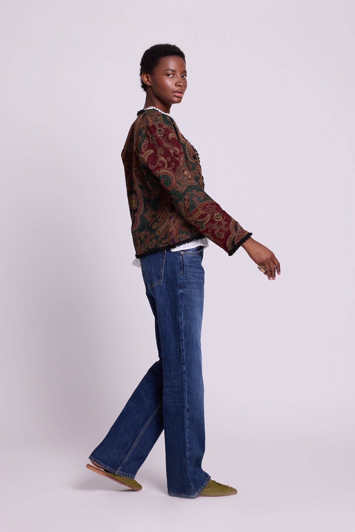 Side view of Kleed Green Oak Jacket in pure wool with paisley swirls and frayed edge detailing.
