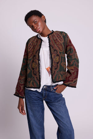Kleed Green Oak Jacket in wool with paisley swirls and cropped silhouette, styled with white top and jeans.