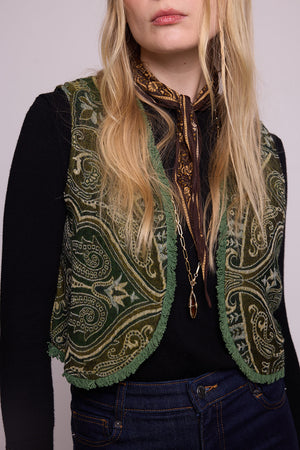 Front close up view of a woman wearing the Kleed Green Paisley Wool Vest over a black long sleeve top