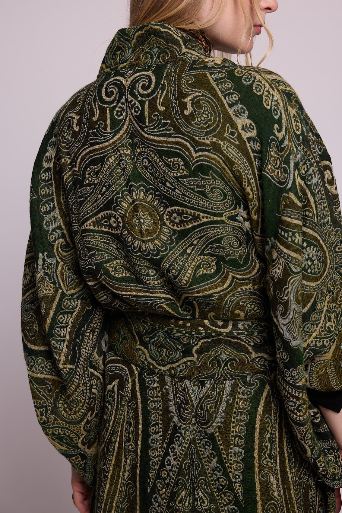Back close up detail of the Kleed Green Paisley Wool Kimono Coat showing the intricate handcrafted green and gold paisley pattern and fabric texture