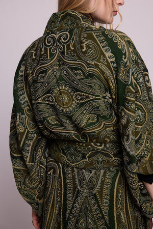 Back close up detail of the Kleed Green Paisley Wool Kimono Coat showing the intricate handcrafted green and gold paisley pattern and fabric texture