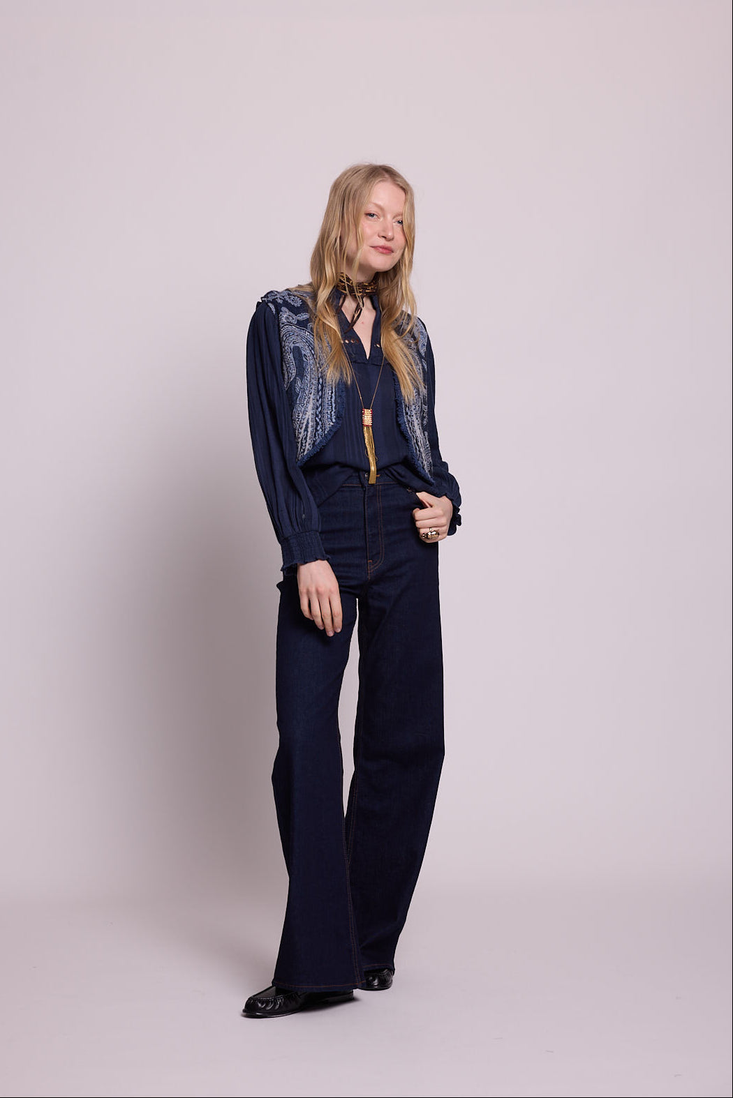 Full length front view of woman wearing the Kleed Blue Paisley Vest in navy wool with wide leg trousers