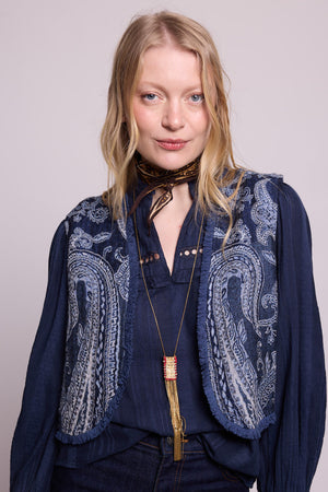 Woman wearing the Kleed Blue Paisley Vest in navy wool, styled with a matching navy blouse, gold pendant necklace and dark scarf