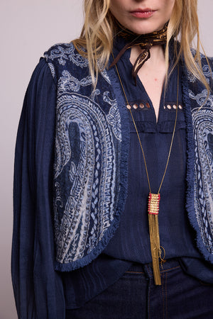 Close up detail of the Kleed Blue Paisley Vest showing intricate white paisley pattern and fringe trim 