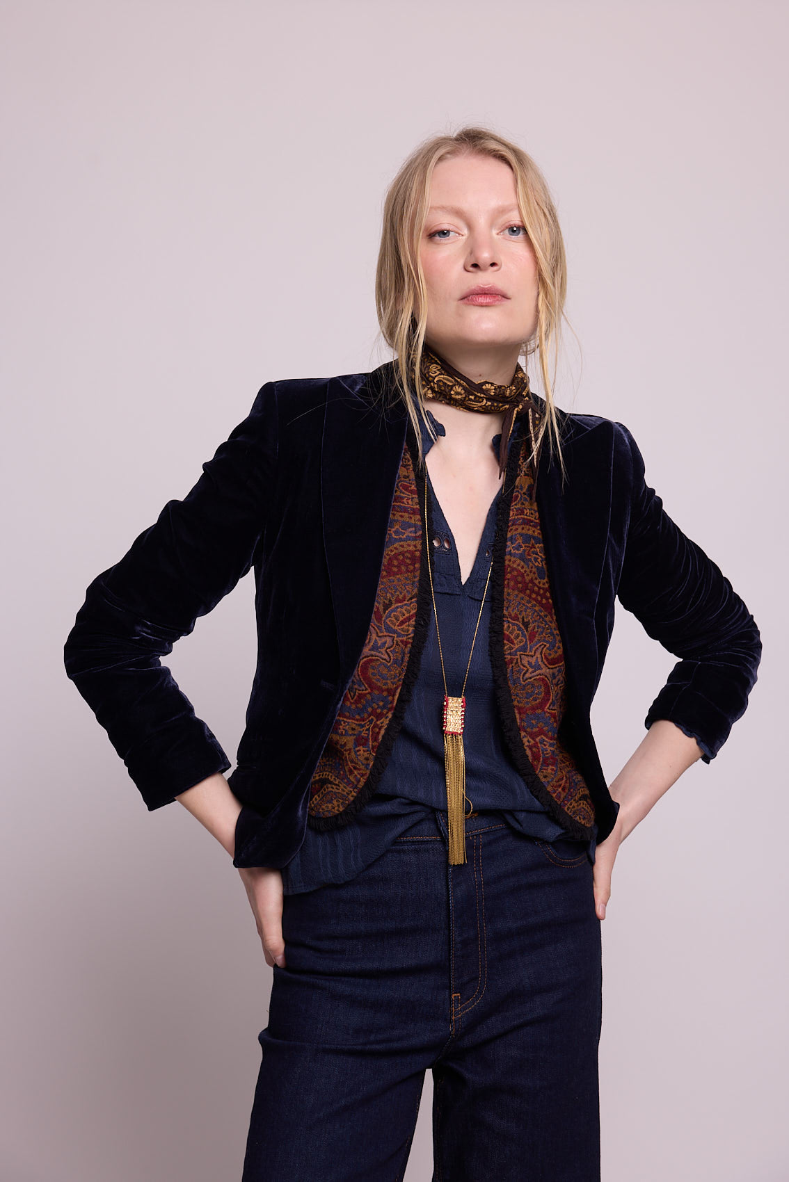 Model standing wearing Kleed Blue Oak Vest in pure wool, layered over a blue velvet blazer and styled with navy trousers.