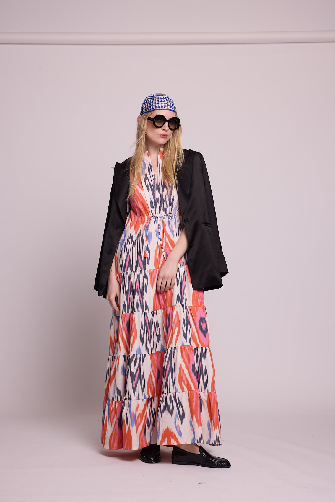 Full length view of a woman wearing the Kleed Tangerine Bikaner Maxi Dress in handloomed cotton ikat styled with a black blazer
