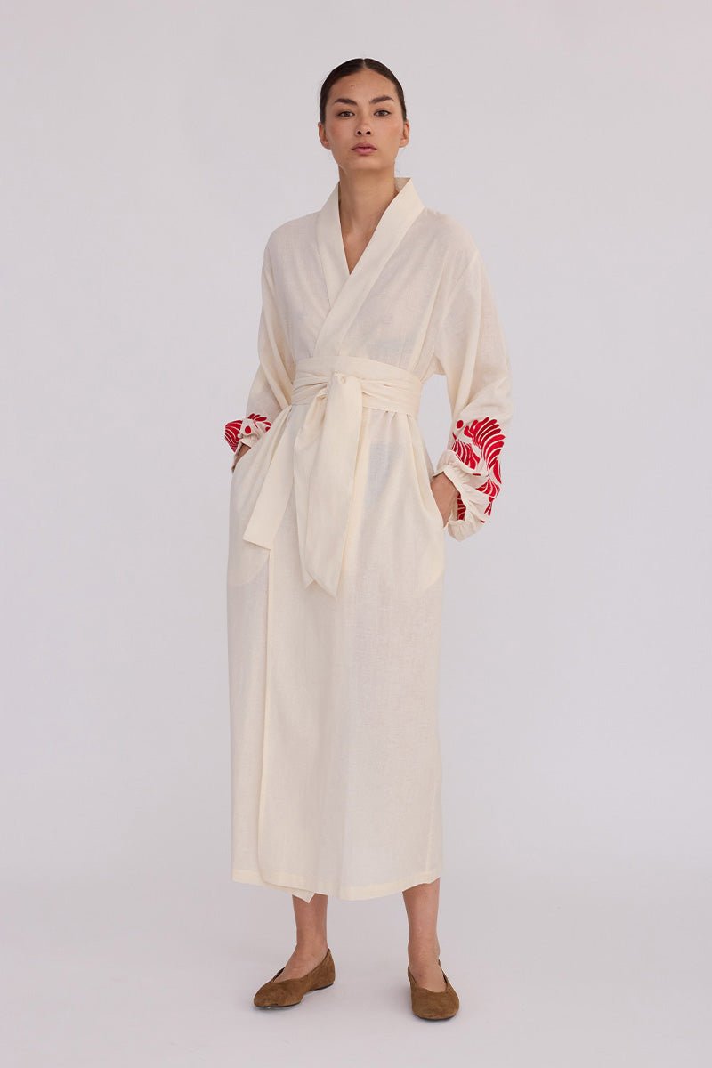 Woman wearing Kleed Natural Kandy Kimono in 100% cotton ivory white with red floral embroidered cuffs front view studio