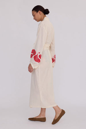 Woman wearing Kleed Natural Kandy Kimono in 100% cotton ivory white balloon sleeves red floral embroidery side view studio
