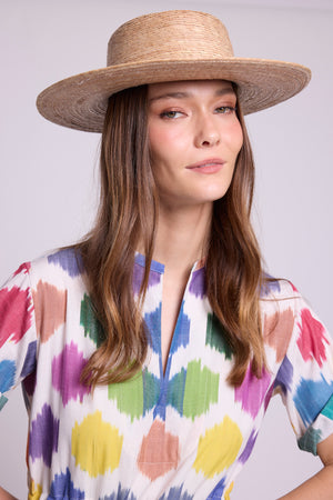 Close up of model wearing anouk dress by kleed 100% cotton ikat and a straw hat. 