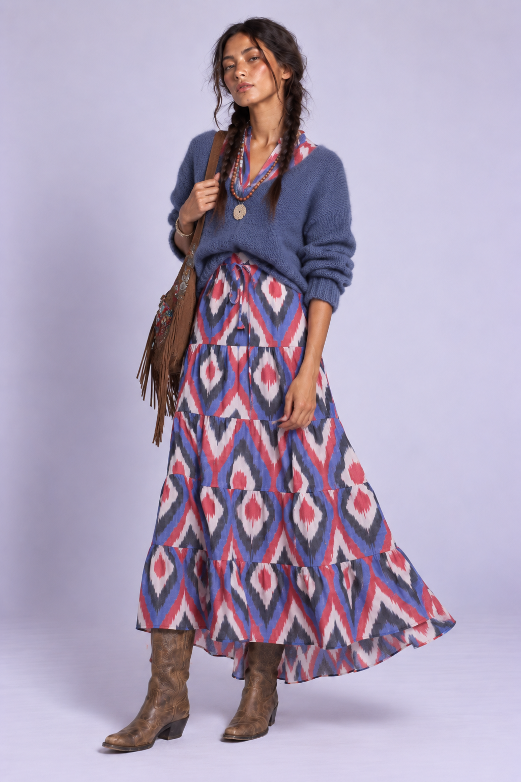 Model wearing the Bahu Bikaner Dress by KLEED, a handloomed cotton ikat maxi dress styled with blue knitwear, layered boho necklaces and cowboy boots.