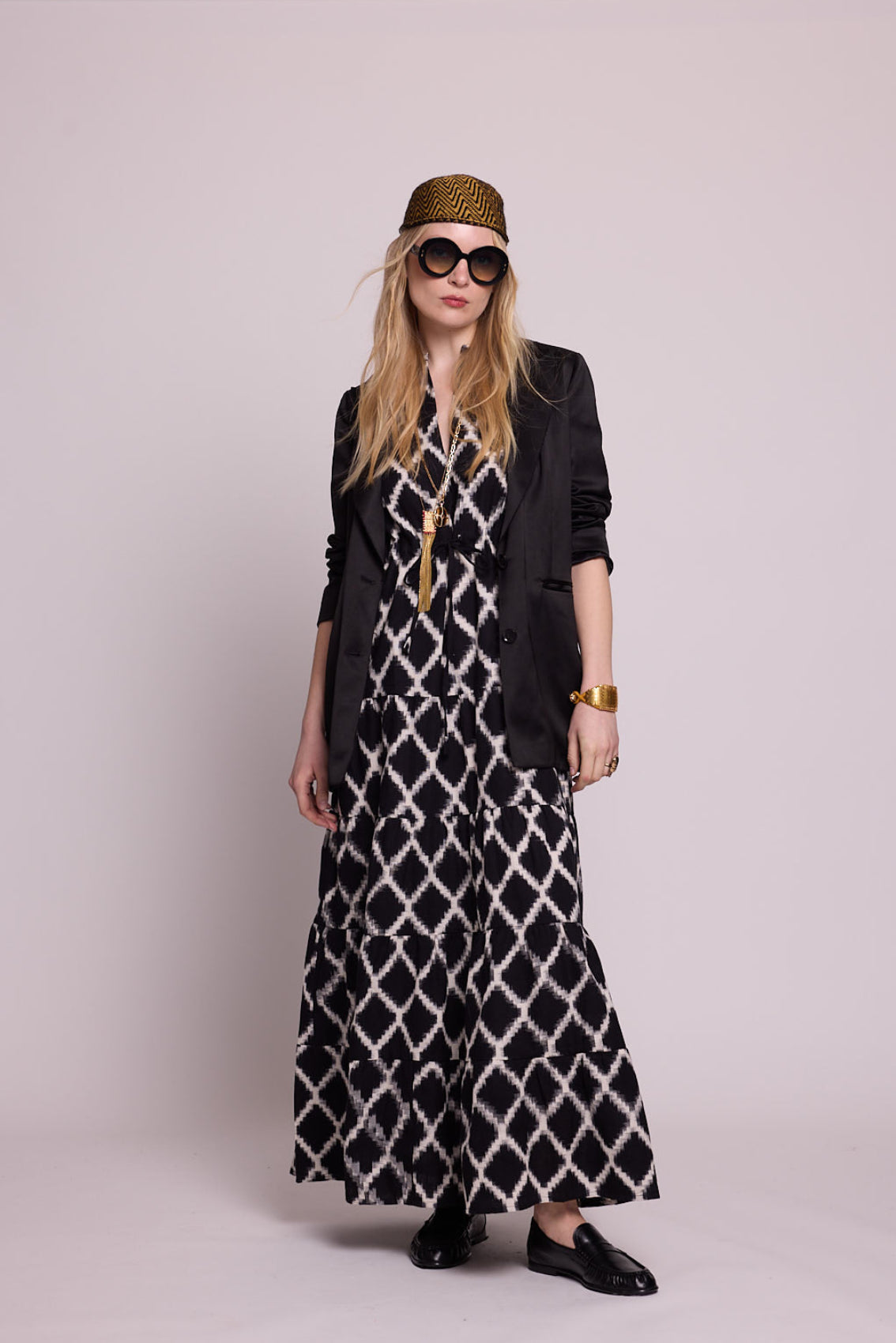 KLEED Black Bikaner Dress, women’s cotton maxi dress in 100% handloomed cotton ikat with a black and white geometric pattern, styled with a black blazer, loafers and oversized sunglasses for elevated resortwear and handcrafted clothing.