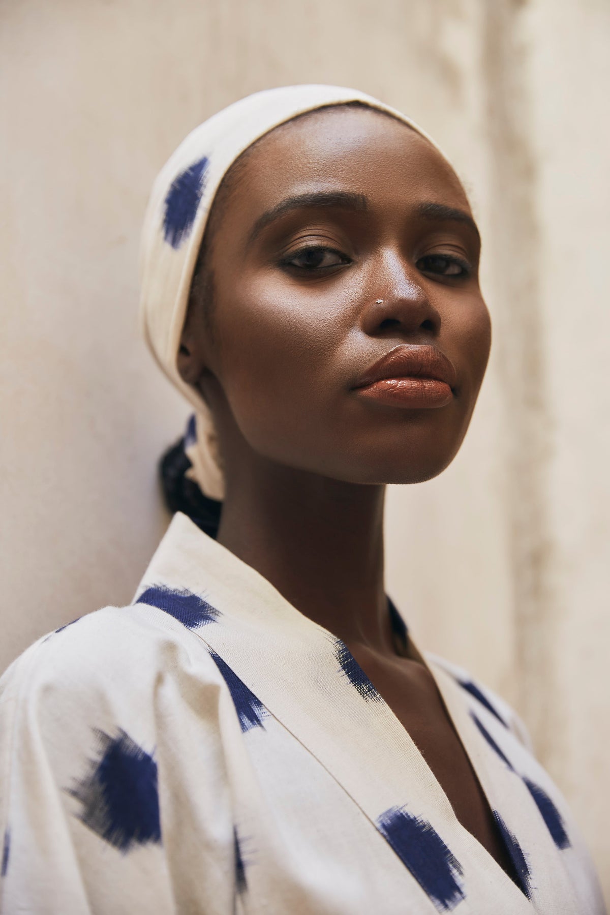 Close up portrait of woman wearing Kleed Blue Dots Bee Kimono in handwoven Ikat cotton cream and navy polka dot pattern outdoor