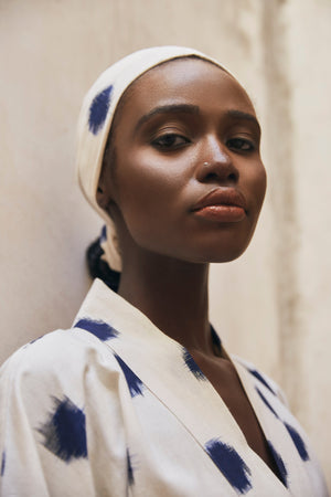 Close up portrait of woman wearing Kleed Blue Dots Bee Kimono in handwoven Ikat cotton cream and navy polka dot pattern outdoor