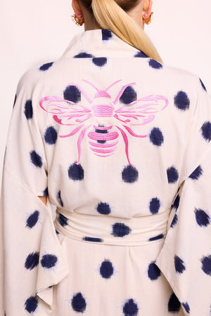 Close up of pink bee hand embroidery on back of Kleed Blue Dots Bee Kimono in handwoven Ikat cotton cream and navy