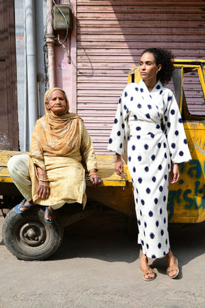 Woman wearing Kleed Blue Dots Bee Kimono in handwoven Ikat cotton cream navy polka dot pattern in Jaipur India street editorial
