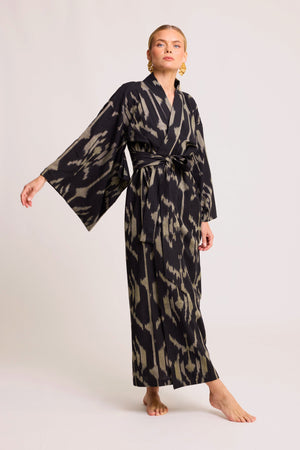 Woman wearing Kleed Congo Naya Kimono in handloomed Ikat cotton black and khaki abstract pattern front view studio