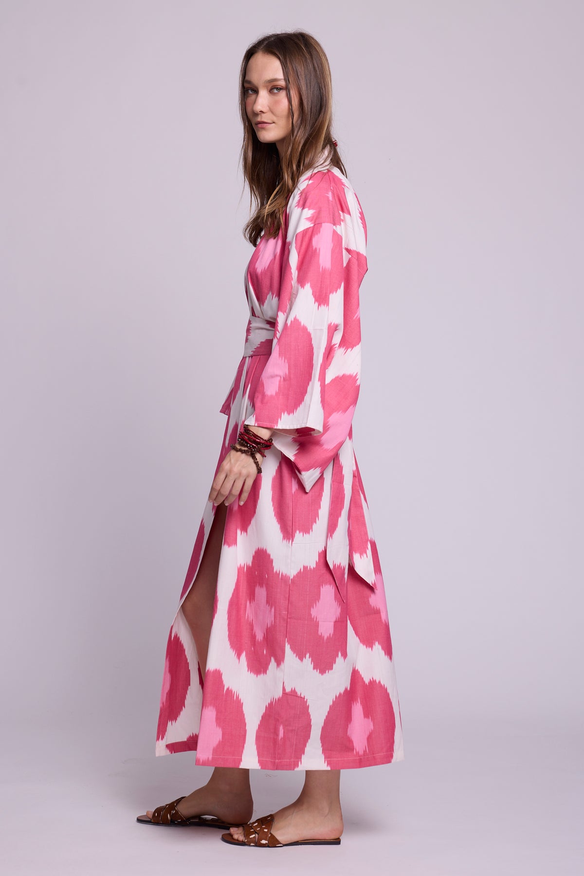 Side view of Hira Pink Kimono by KLEED — maxi length handloomed ikat cotton kimono with bold pink circle print and wrap belt