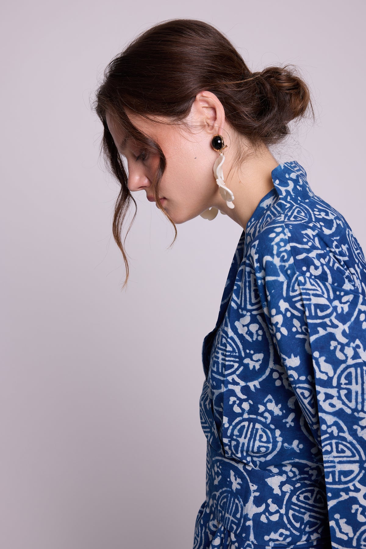 Close-up side view of a woman wearing KLEED’s limited-edition Indira Bloom Kimono, crafted in 100% chemical-free indigo blue and white hand block-printed cotton, highlighting the collar and artisanal print.