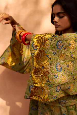 Detail of the Kleed Jasmine Kimono showing hand block printed yellow and olive feather print on lightweight cotton