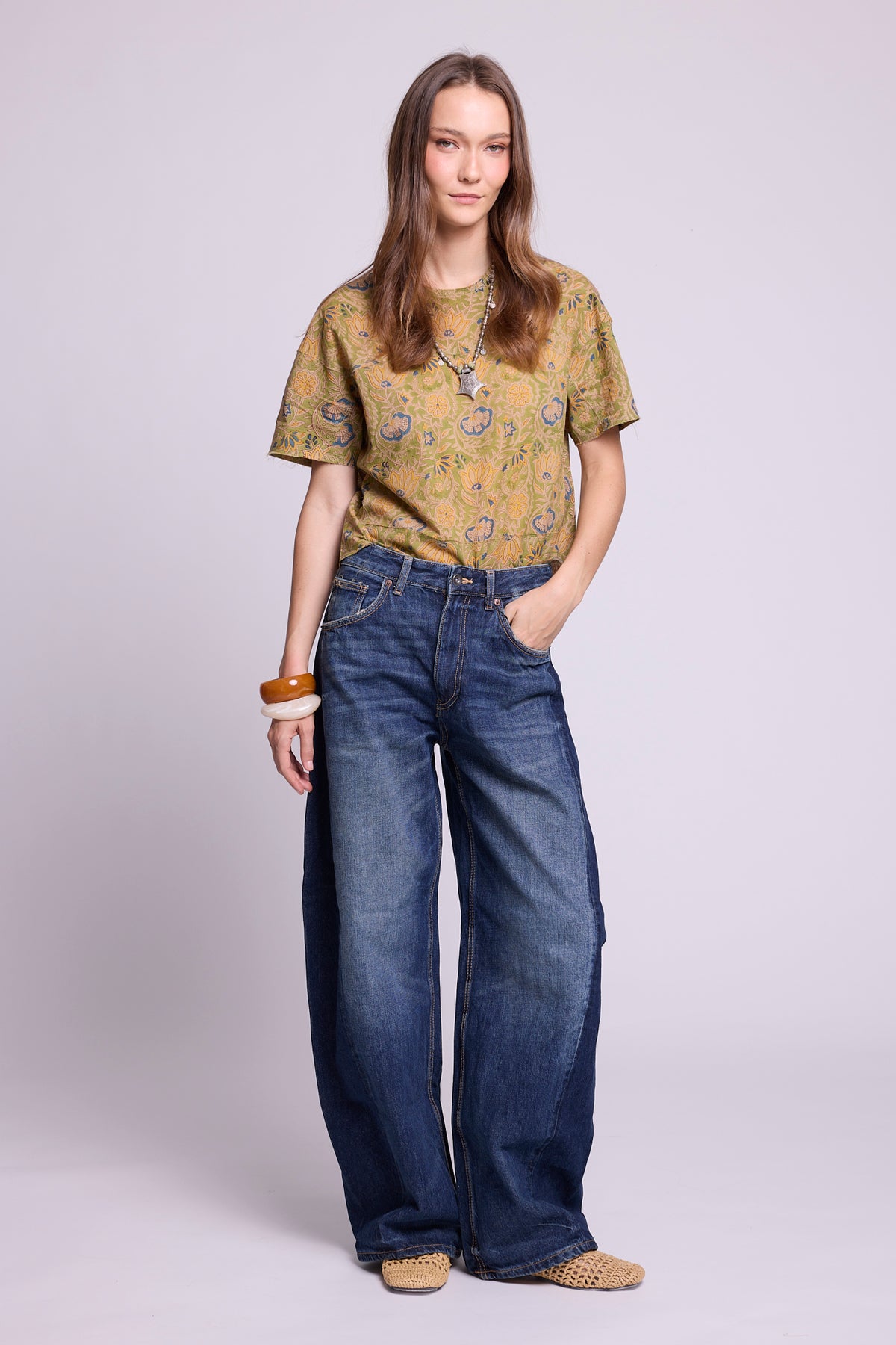 KLEED Kaner Jasmine Pyjama top — hand block printed cotton in olive green floral, styled with wide leg jeans