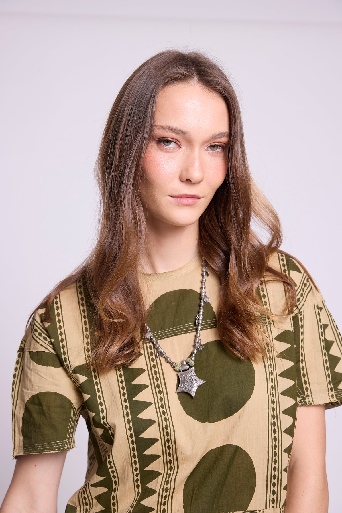 Close-up of KLEED Kaner Khaki Geo Pyjama top — 100% cotton with bold olive geometric and stripe print