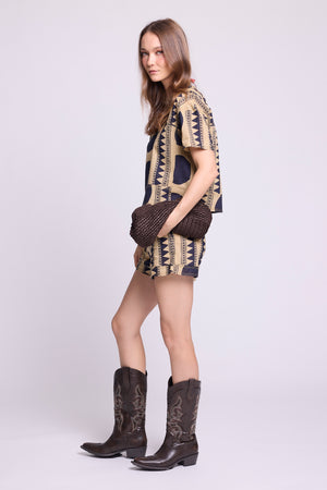 Side view of KLEED Kaner Midnight Geo Pyjama — sustainable cotton set with oversized navy circle and tribal stripe print