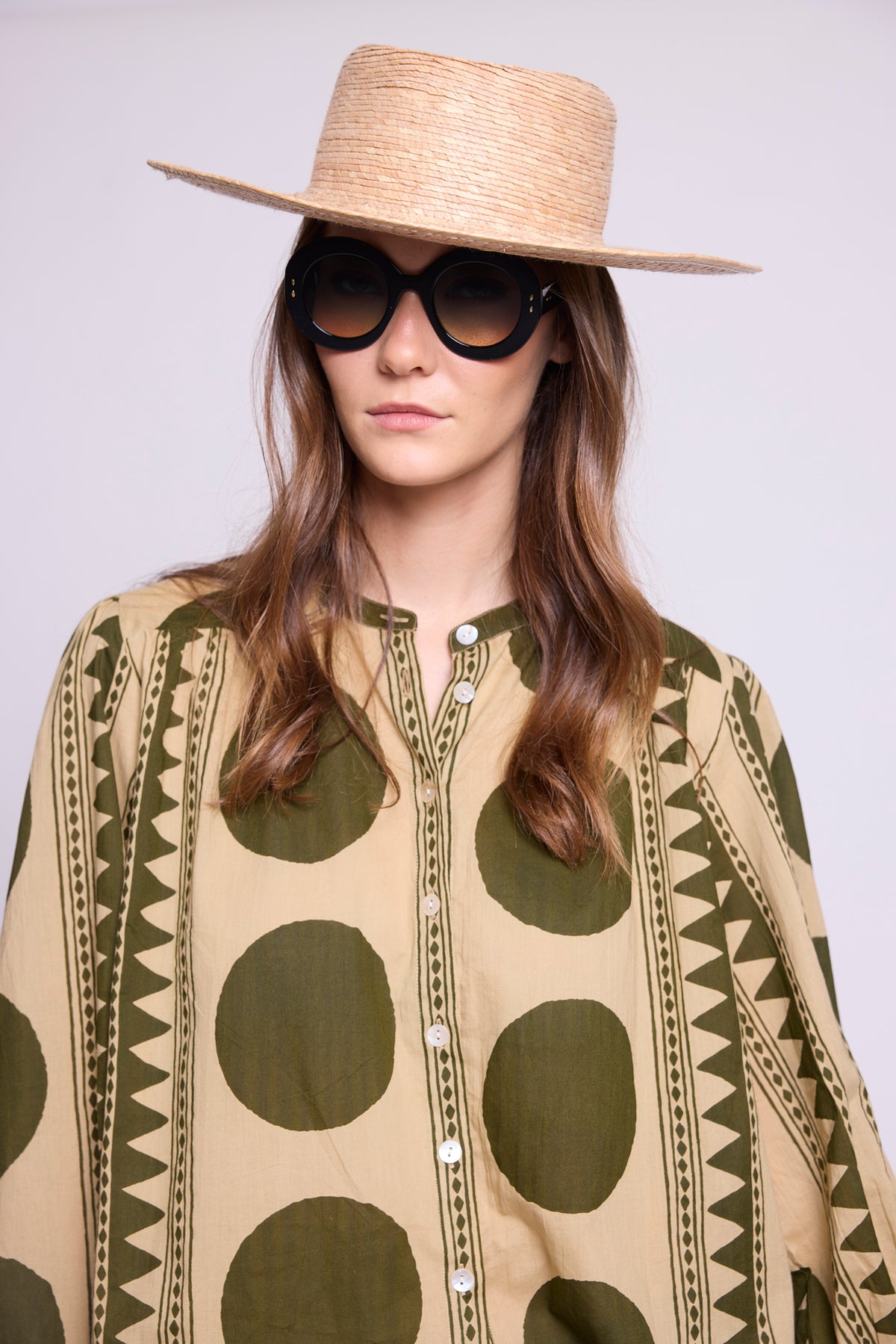 Model wearing the KLEED Khaki Geo Balloon Shirt in 100% cotton, close-up showing the khaki and sand geometric print and balloon sleeves.