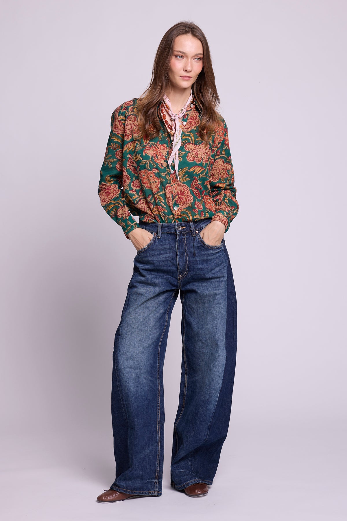 KLEED Lotus Green Shirt, women’s cotton shirt in 100% hand block printed cotton with a rich green floral print, mother-of-pearl buttons and relaxed fit, styled with wide-leg denim in a clean studio fashion photo.