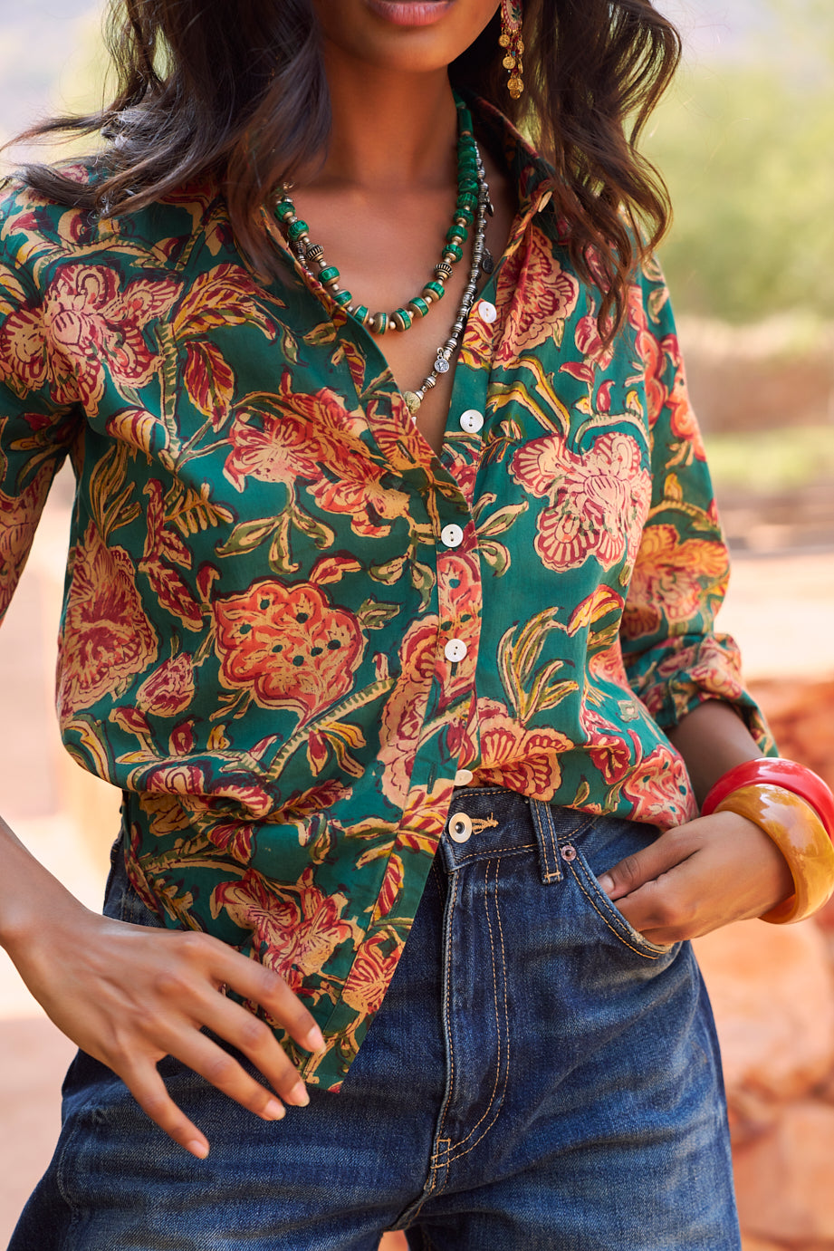 Close-up of model wearing the KLEED Lotus Green Shirt in 100% cotton, highlighting the artisanal hand block floral print and mother-of-pearl buttons.