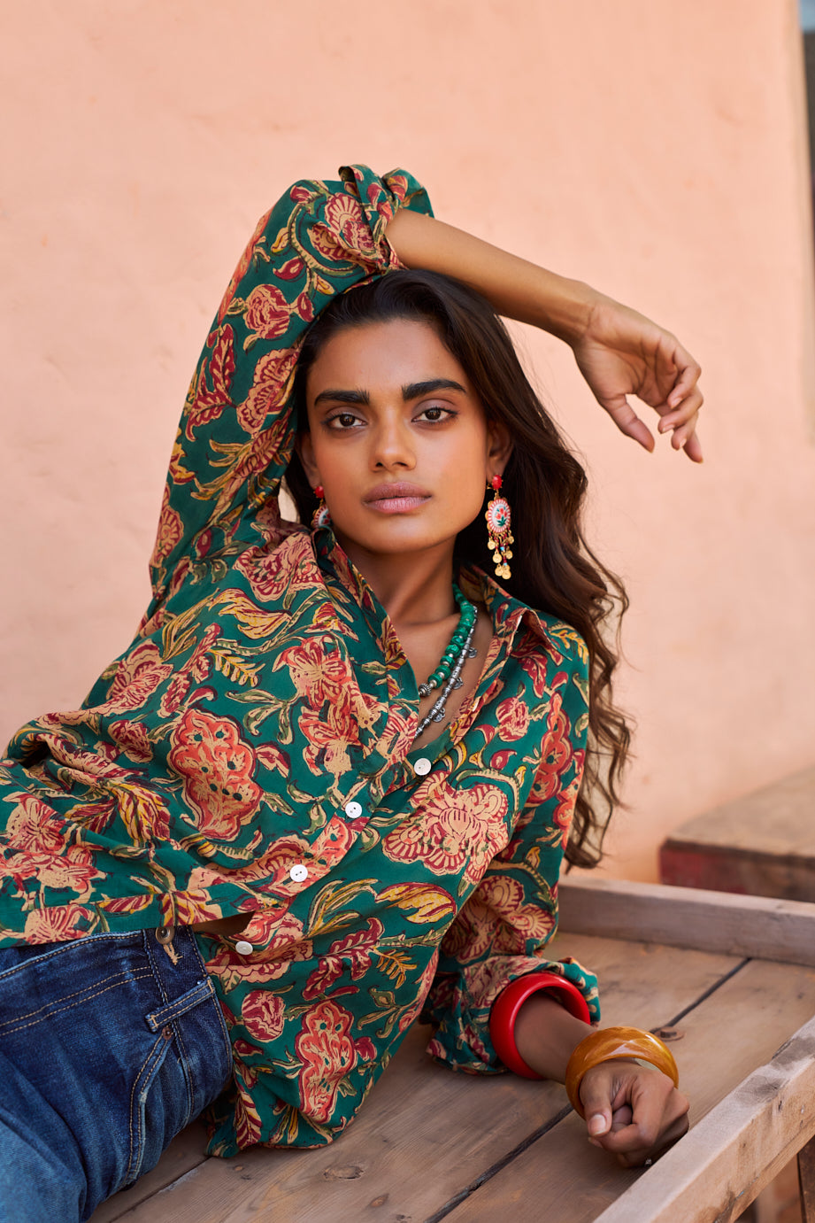 Woman wearing Kleed Green Lotus Shirt, a hand block printed 100% cotton shirt with green and coral floral print, styled with denim jeans