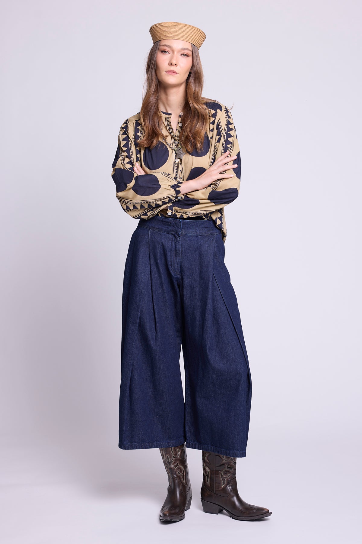 KLEED Midnight Geo Balloon Shirt in 100% cotton, styled with wide-leg dark denim trousers and brown boots, featuring a navy and sand geometric print and voluminous sleeves.