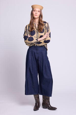 KLEED Midnight Geo Balloon Shirt in 100% cotton, styled with wide-leg dark denim trousers and brown boots, featuring a navy and sand geometric print and voluminous sleeves.