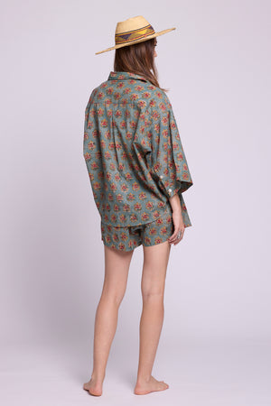  Back view of Mogra Hara Pyjama by KLEED — hand block printed 100% cotton oversized shirt and shorts in sage green floralBack view of Mogra Hara Pyjama by KLEED — hand block printed 100% cotton oversized shirt and shorts in sage green flora