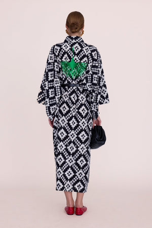 Woman wearing Kleed Mombasa Black Kimono in handloomed Ikat cotton black and white geometric pattern back view studio