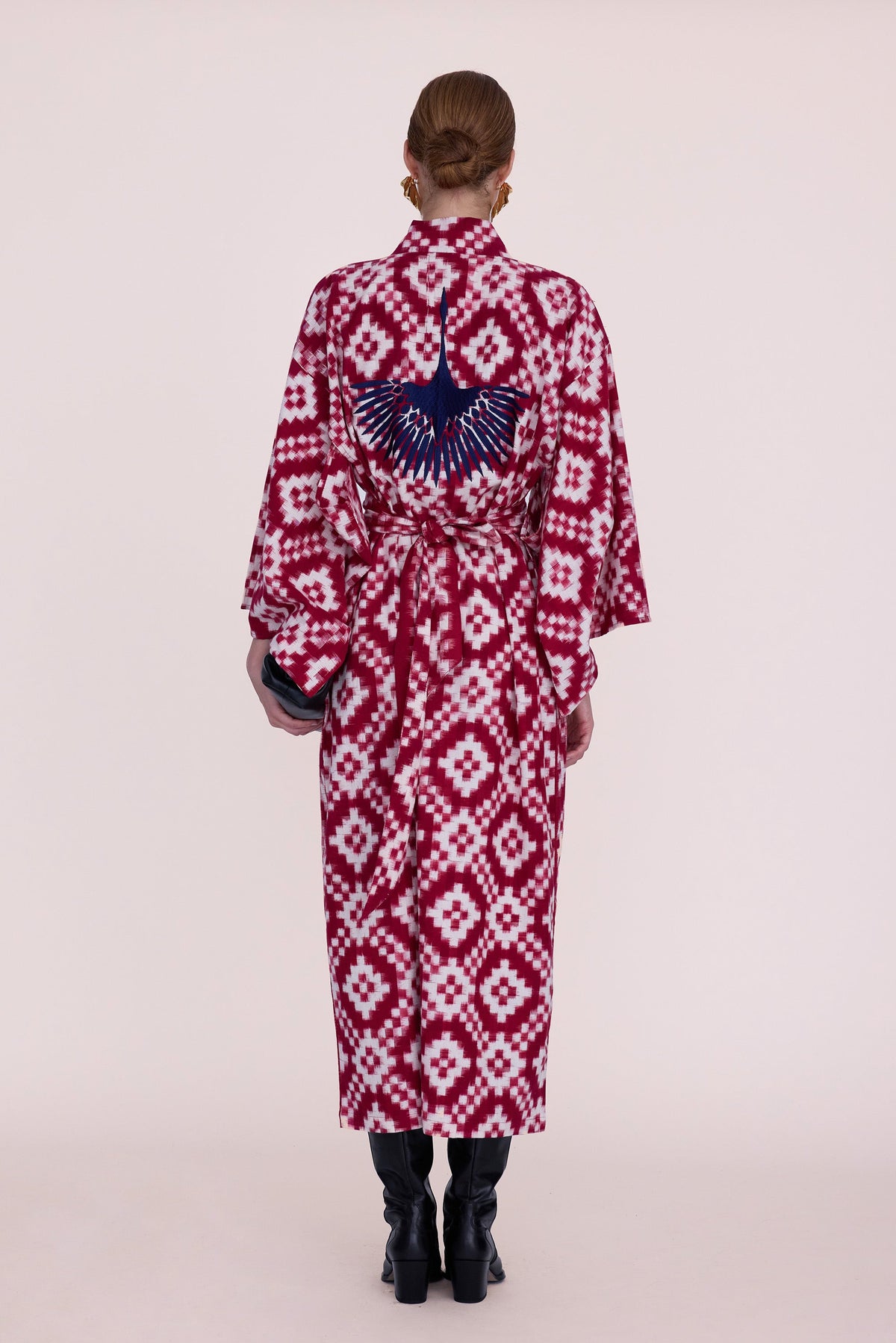 Back side of the Mombasa red Ikat cotton kimono with hand embroidered navy bird, Kleed