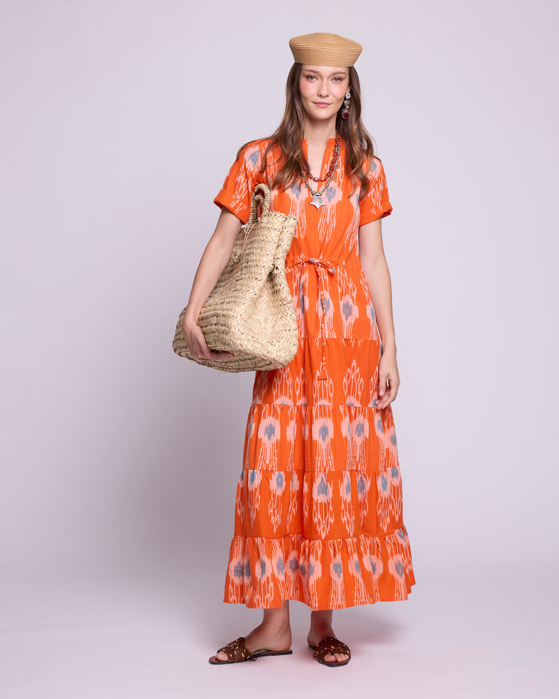Woman wearing KLEED Orange Bikaner Ikat Dress, handloomed ikat cotton, sustainable luxury resortwear