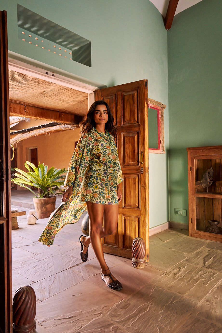 Model wearing the Kleed Palash Kimono open over the matching Palash shorts, a handcrafted cotton co-ord set in cream with hand block printed floral motifs