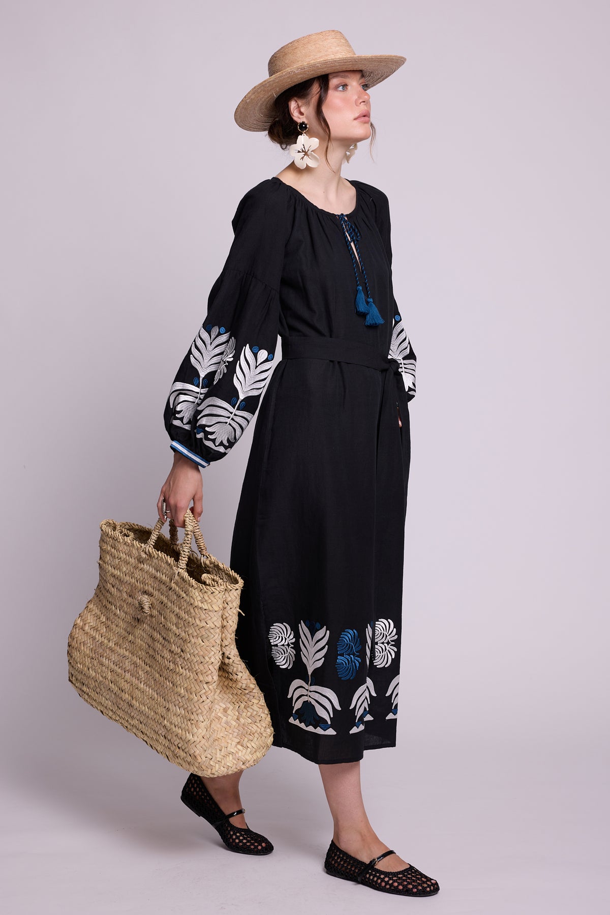 Full-length front view of model wearing the KLEED Portofino Black Kaftan with embroidered cuffs and hem.